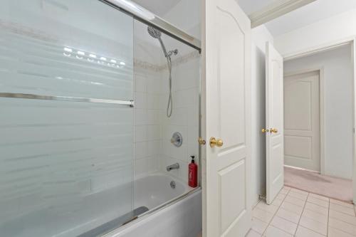 a bathroom with a shower with a glass door at Home Base Quiet Queen Rooms in Richmond