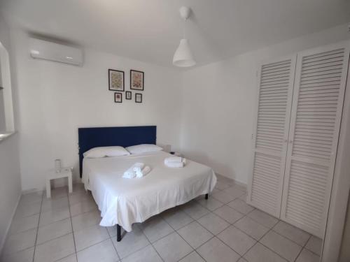 a bedroom with a white bed with two towels on it at Casa Francesca Ponza in Ponza
