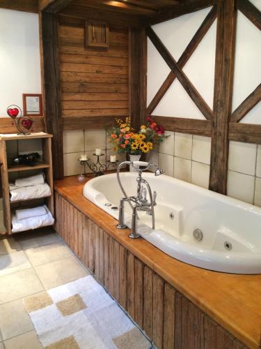a bath tub in a bathroom with wooden walls at Romantikzimmer Jakobbauer in Turnau
