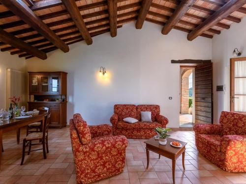 a living room with red chairs and a table at Apartment in Sant'Angelo near Medieval Town in SantʼAngelo in Vado