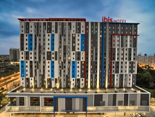 a building with a hicks hotel sign on top of it at ibis Bangkok IMPACT in Nonthaburi
