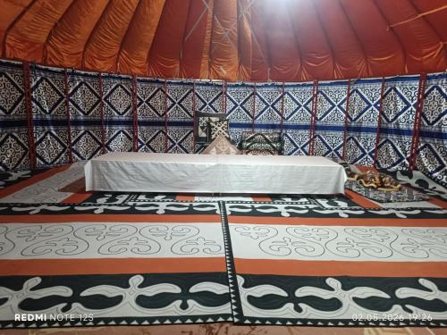 a bedroom with a bed in a tent at KochevniK in Almaty