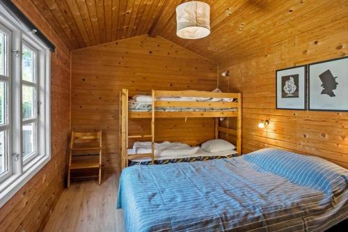 a bedroom with bunk beds in a wooden cabin at 3032-Stege-Ankeret-4 in Stege