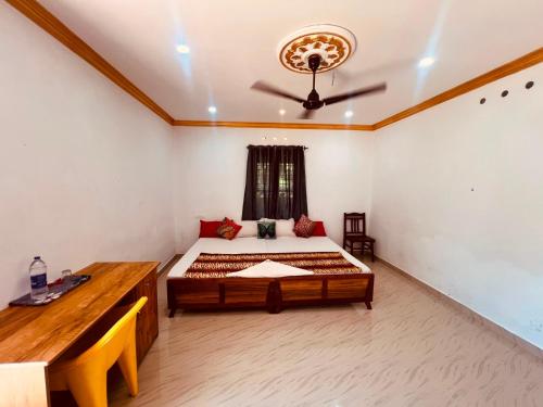 a bedroom with a large bed in a room at Rooms Varkala Homestay in Varkala