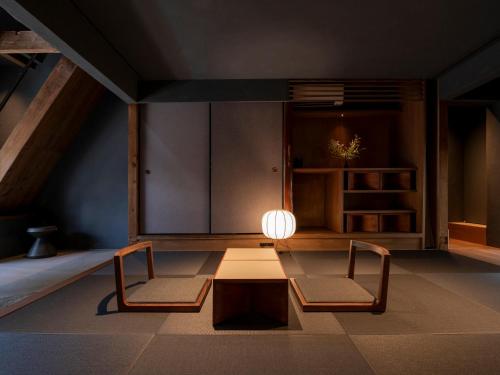 a living room with two chairs and a table at MU HEN KO Q -Nara- in Nara
