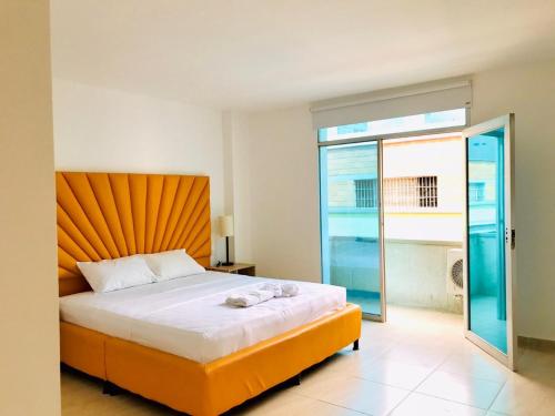 a bedroom with a bed and a large window at Mejor Hotel, Centro Medellín, Opera, adults only entertainment in Medellín