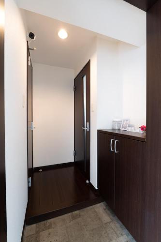 a hallway with a door leading to a room at Ruis Hakata in Fukuoka