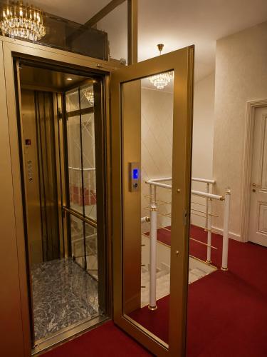 an open door in a room with a mirror at Central City Department Hotel in Baku
