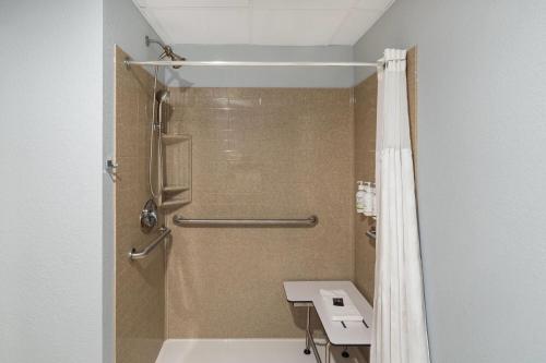 a bathroom with a shower and a sink at Baymont by Wyndham Oacoma in Oacoma