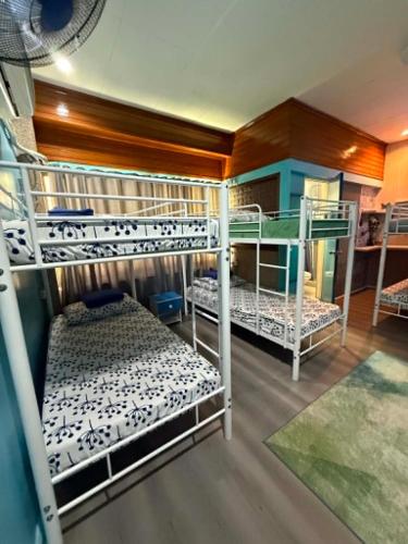a room with three bunk beds in it at Peach Haven in Cebu City
