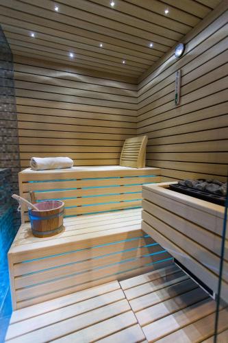 a sauna with a tub and a bucket in it at Hotel Crikvenica in Crikvenica