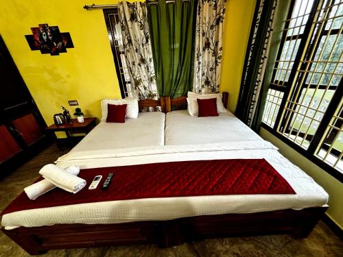 a bedroom with a large bed in a room at Muthu Seaview Residency in Kuilapayam