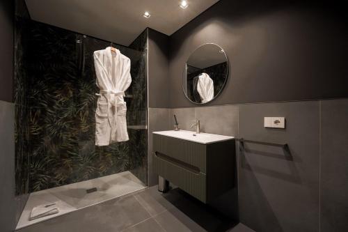 a bathroom with a sink and a shower and a mirror at Roberto Verde House SPECTRE Luxury Suite in Verona