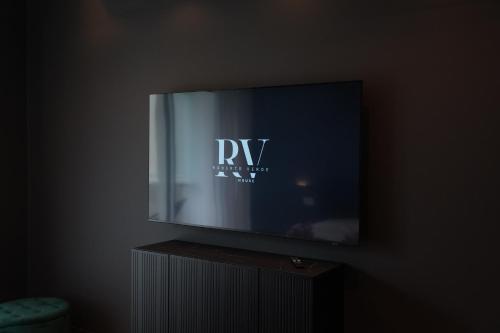 a flat screen tv sitting on top of a stand at Roberto Verde House SPECTRE Luxury Suite in Verona