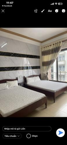a bedroom with two beds and a window at My Anh Guest House in Da Lat