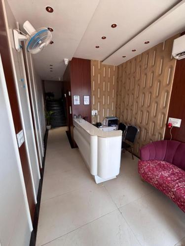 an office with a desk and a couch in a room at Hotel Corporate in Shivpurī