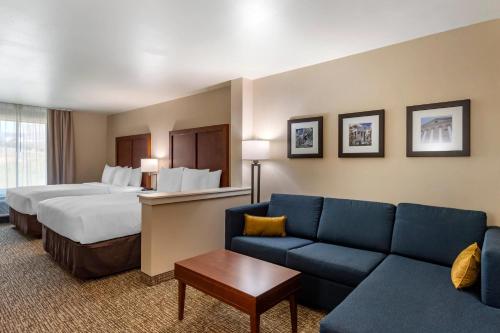 a hotel room with a bed and a couch at Comfort Inn & Suites Charlottesville Hollymead Town Center in Charlottesville