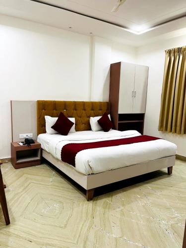 a bedroom with a large bed in a room at Hotel Anand Inn in Kota