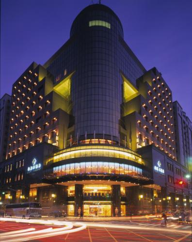 a large building at night with a street in front at Monarch Plaza Hotel in Taoyuan