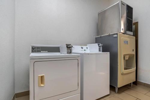 a small kitchen with a refrigerator and a microwave at Comfort Suites Hattiesburg near University in Hattiesburg