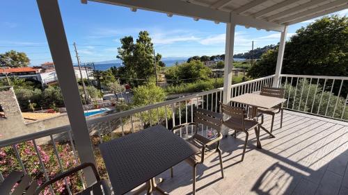 a balcony with a table and chairs and a view at Golden Evelyn in Agia Paraskevi