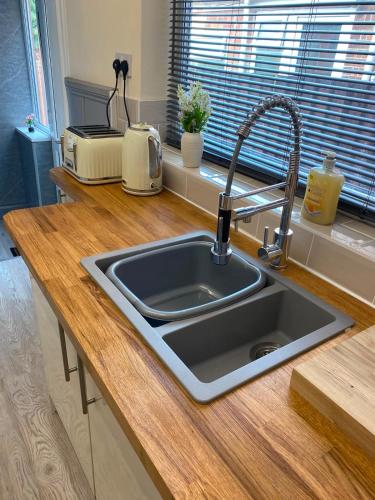 a kitchen counter with a sink in a kitchen at Bide a Sea in Gorleston-on-Sea