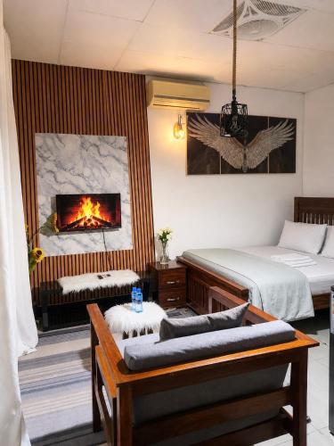 a bedroom with two beds and a fireplace at 1BDM Aptmt Free Wifi,TV, NETFLIX,FRIDGE,KITCHEN-busy area in Dar es Salaam