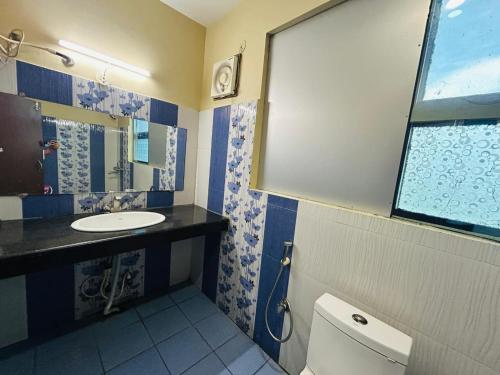 a bathroom with a sink and a toilet at Hotel Sky View in Aurangābād