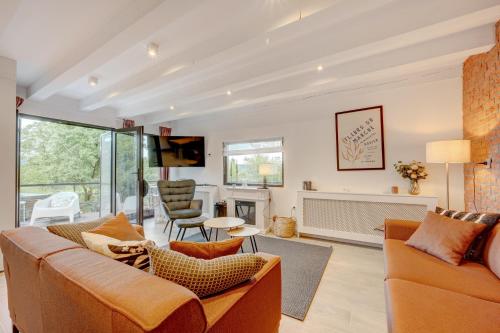 a living room with a couch and a fireplace at Forest House Premium Breaza in Breaza de Sus