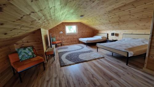 a bedroom with a large bed and a room with a bed sqor at Villa Las Palmas in Strzeszów