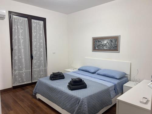 a bedroom with two beds with towels on them at home SIKAN casa al mare Licata in Butera