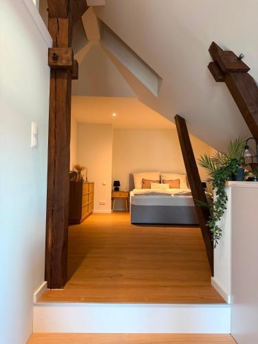 a bedroom with a bed and wooden beams at Loft Günni mit Whirlpool in Wietzendorf