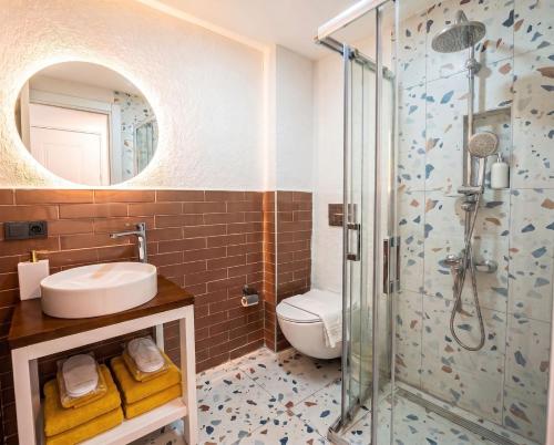 a bathroom with a toilet and a sink and a shower at Kiva Alaçatı Hotel By Amarillo in Çeşme