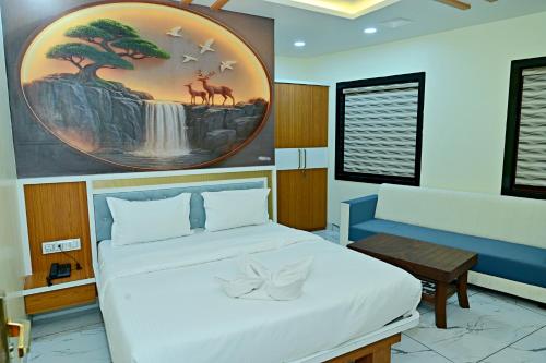 a bedroom with a bed and a painting on the wall at Gehlot Paradise Hotel in Nāgaur