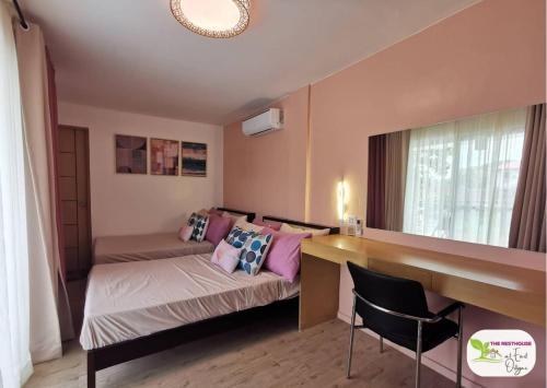 a small room with a bed and a desk and a table at Newly Built Private Villa with Pool in Cainta in Cainta