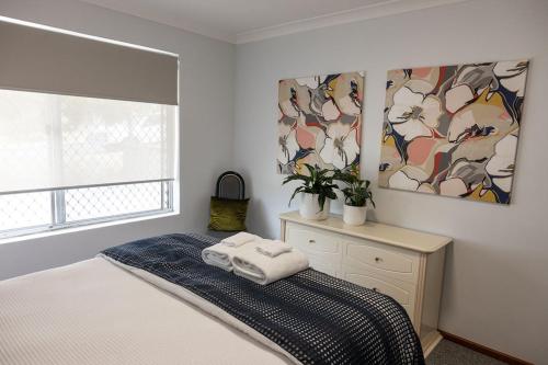 a bedroom with a bed with two towels on it at Something a little different in Albany