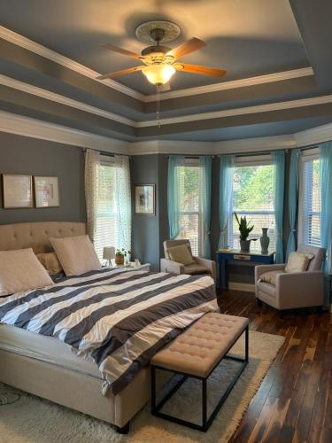 a bedroom with a bed and a ceiling fan at Karibuni Braselton in Braselton