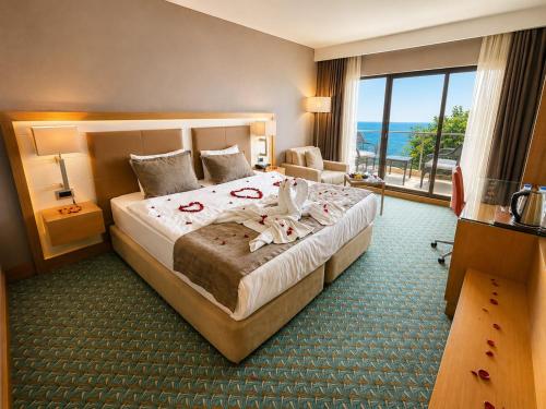 a hotel room with a bed and a large window at Blue Sea Hotel in Trabzon