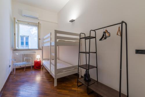a room with two bunk beds and a window at Effealatapartments - Appartamento del Duca in Senigallia