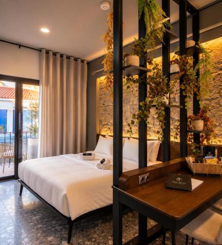 a bedroom with a bed and a wooden table at Well Being Luxury Apartments in Evdilos