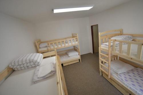 a dorm room with three bunk beds in it at Relaxační centrum Orion in Roudná