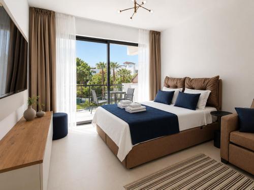 a bedroom with a large bed and a balcony at Esentepe Collection Nothern Cyprus Villas & Apartments with Sea View Nothern Cyprus in Pallouriotissa