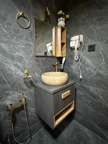 a bathroom with a sink and a mirror at Golden Star Cottage in Kazbegi