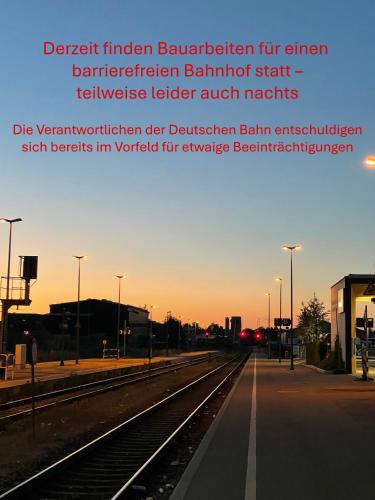 a train station with train tracks in the foreground at Hotel Am Gleis 1 - Self-Check-In in Sonthofen
