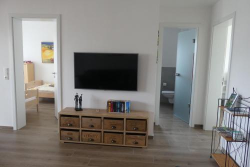 a living room with a television on a wall at Ferienwohnung Wolkenfeld in Kaisersesch