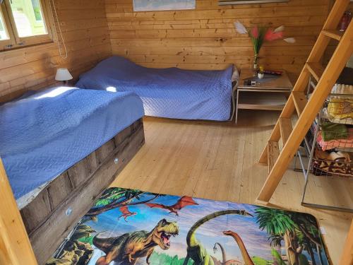 a bedroom with a bed with a painting of dinosaurs at Aiamaja Sindi Location Sindi Kirsi 3 in Pärnu