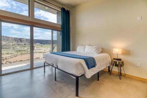 a bedroom with a bed and a large window at Crooked River Ranch Cabins in Terrebonne