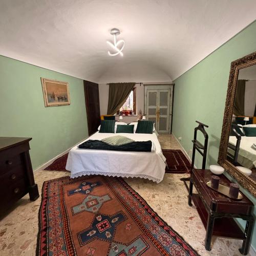 a bedroom with a bed and a large mirror at Oasi di pace in Romano Canavese