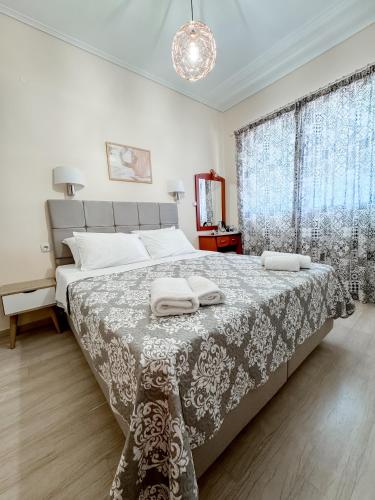 a bedroom with a large bed with two towels on it at Avli Studios in Nydri