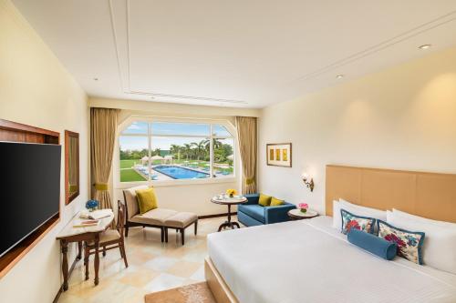 a hotel room with a bed and a large window at Tajview, Agra-IHCL SeleQtions in Agra
